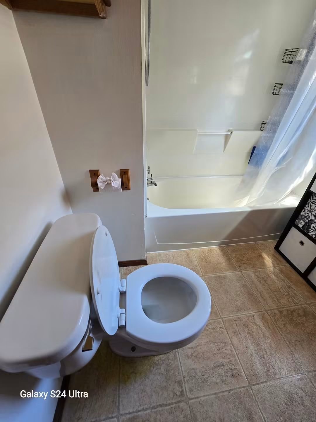 Same bathroom after cleaning — sparkling toilet, tub, and tile