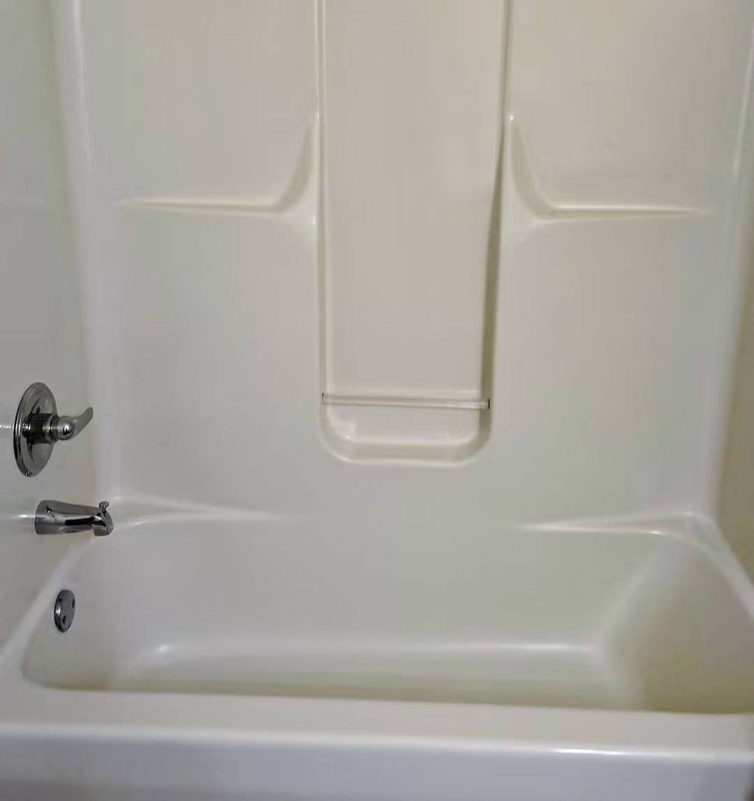 Same bathtub gleaming white after a deep clean