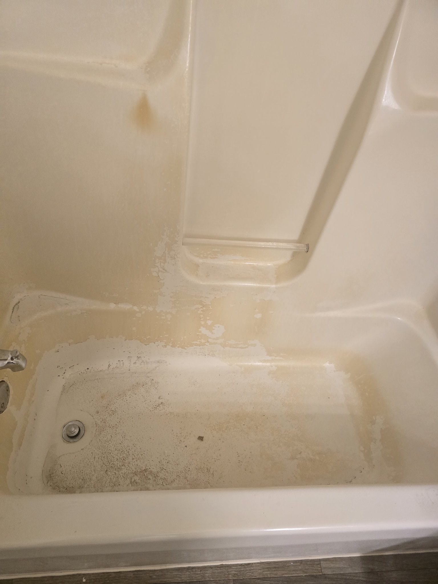 Bathtub before cleaning — stained, grimy surface